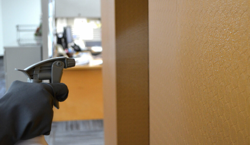 Daily disinfecting of wallcovering in high traffic area in an office building.